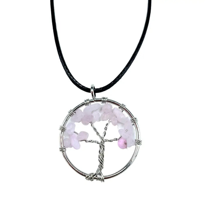 A gemstone tree of life pendant with silver wire and rose quartz chips on a black cord