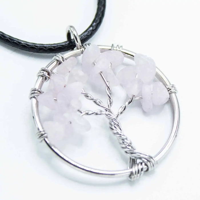 Silver wire-wrapped gemstone tree of life pendant with rose quartz chips on a black leather cord