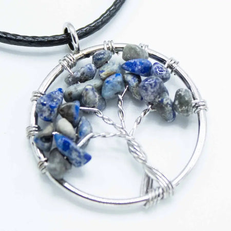Silver wire-wrapped gemstone tree of life pendant with natural blue and gray lapis lazuli stones in sodalite colors