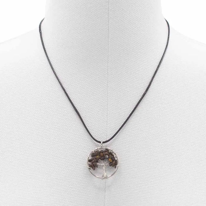 Silver-toned circular life pendant with tiger eye stones on black cord offering grounding energy benefits