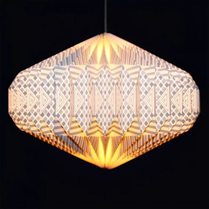 Geometric origami paper pendant light shade in warm yellow with patterned design and soft illumination