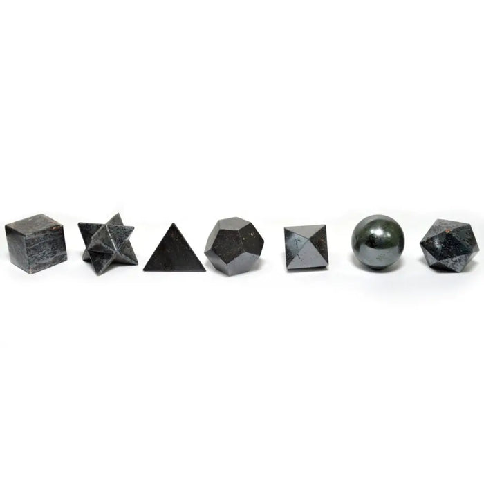 Set of seven piece crystal set with polished black magnetic hematite shapes including cube star and sphere