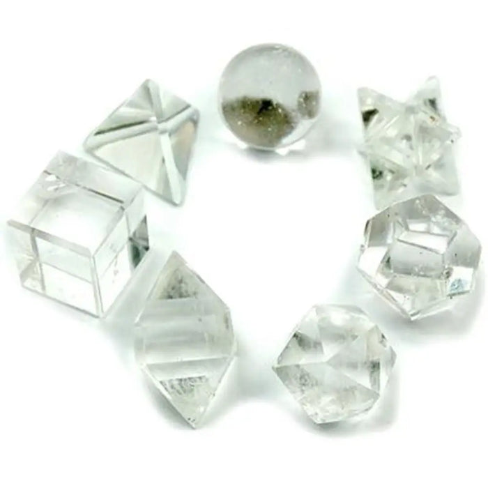 Clear quartz seven piece crystal set with clear faceted gemstones in geometric shapes like cubes and pyramids