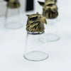 Golden owl-headed antique bronze stopper on a clear glass shot glass from mystical creatures gift set