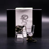 A clear glass shot glass with a golden tiger-head stopper and base from the mystical creatures shot glasses set