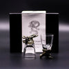 A clear glass shot glass with a bronze dragon head stopper and base from mystical creatures shot glasses set