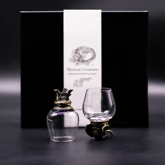 Clear glass dragon-themed decanter with ornate antique bronze cap and base from mystical creatures gift set
