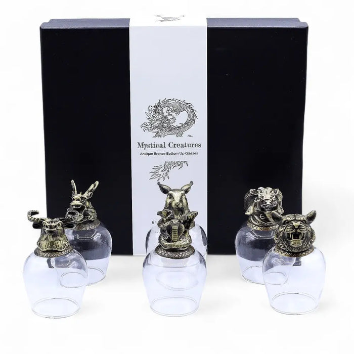 Set of five clear glass drinking glasses with antique bronze mystical creatures on top featuring glass features