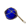 A cobalt blue glass buoy ornament in a natural hessian rope net with a looped handle showing diameter options