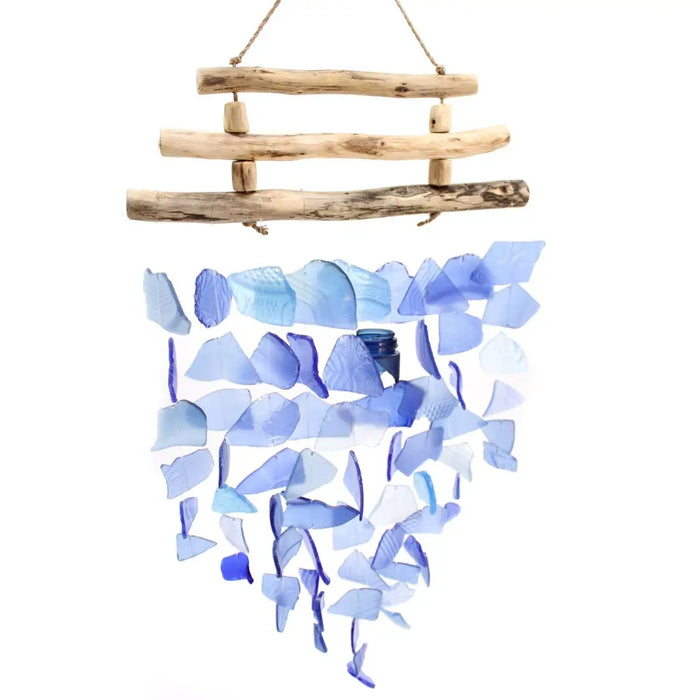 A driftwood wind chime with three sticks made of natural wood and blue translucent glass shards hanging outdoors