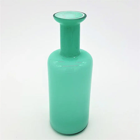 A sleek teal glass reed diffuser bottle with a translucent cylindrical body and a slender neck vase design