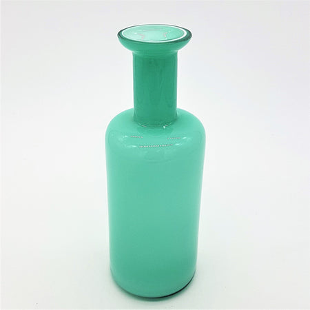 A sleek teal glass reed diffuser bottle with a translucent cylindrical body and a slender neck vase design