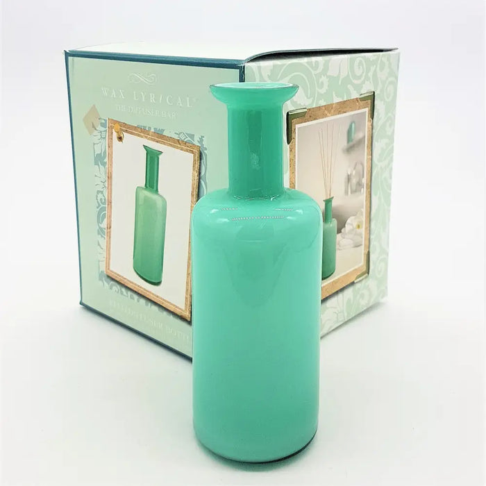 A matte turquoise glass reed diffuser bottle with a slender neck and rounded body for home fragrance use