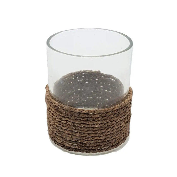 Clear glass votive and tealight holder with a woven brown string base for candle display or decor