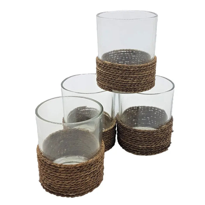 Glass votive and tealight holders made of clear glass with natural brown string trim wrapped around the base