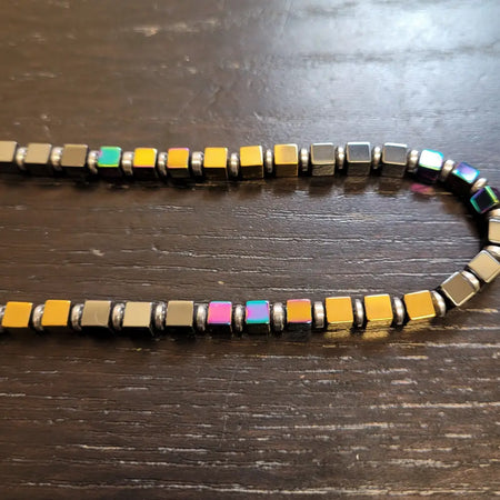 Gold finish magnetic bead necklace with square rainbow hematite beads in yellow green pink and silver spacers