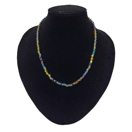 A gold finish beaded necklace with square rainbow hematite glass beads in gold silver blue and purple shades