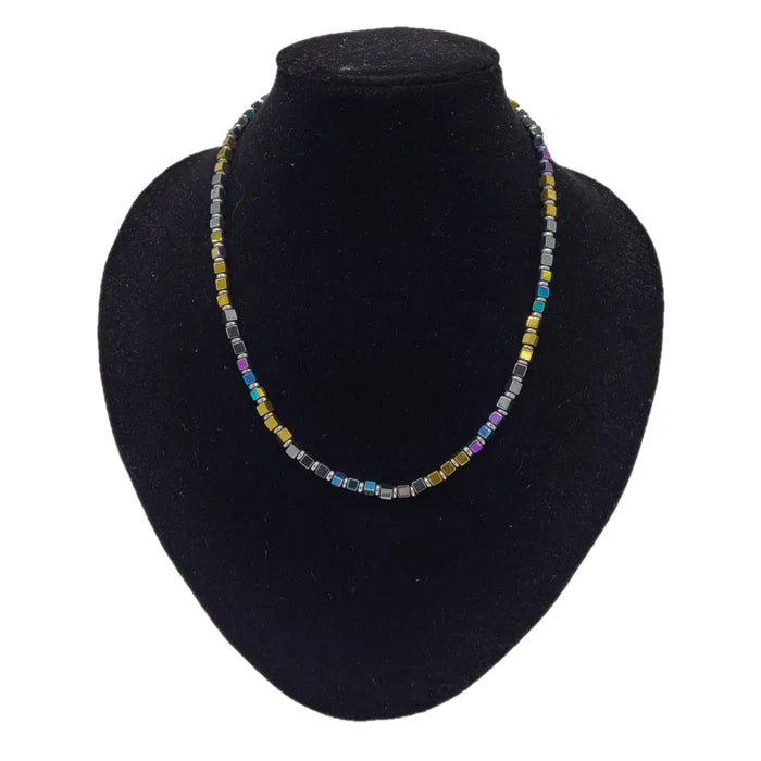 A gold finish beaded necklace with square rainbow hematite glass beads in gold silver blue and purple shades