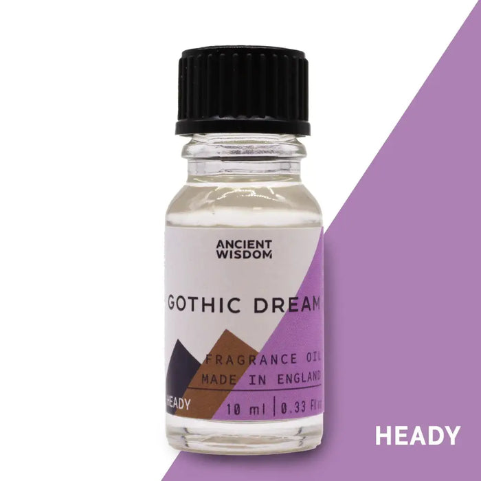 A clear glass bottle with black cap labeled ancient wisdom gothic dream fragrance oil with purple brown geometric design