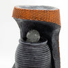 Black textured ceramic greek urn with orange woven rim and clear speckled crystal ball in base grand water feature