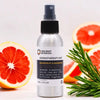 A sleek silver spray bottle labeled ancient wisdom aromatherapy mist with grapefruit and rosemary essential oil to reduce stress levels