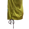 A green cotton appliqué tank vest with stitched flowers paired with a mustard-yellow cotton skirt with drawstring waist