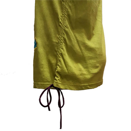 A green cotton appliqué tank vest with stitched flowers paired with a mustard-yellow cotton skirt with drawstring waist
