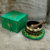 Green tara singing bowl set with a green and gold metal bowl, wooden mallet, and matching green cushion