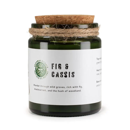 Dark green glass jar soy candle with cork lid and twine labeled fig and cassis by greenman woodwick soy candle