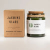 Green glass jar woodwick soy candle with cork lid and twine labeled jasmine glade by woodwick
