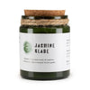 Dark green glass jar woodwick soy candle with cork lid and twine wrap labeled jasmine glade by greenman distills