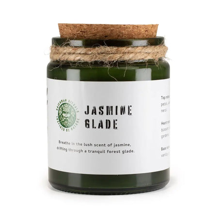 Dark green glass jar woodwick soy candle with cork lid and twine wrap labeled jasmine glade by greenman distills