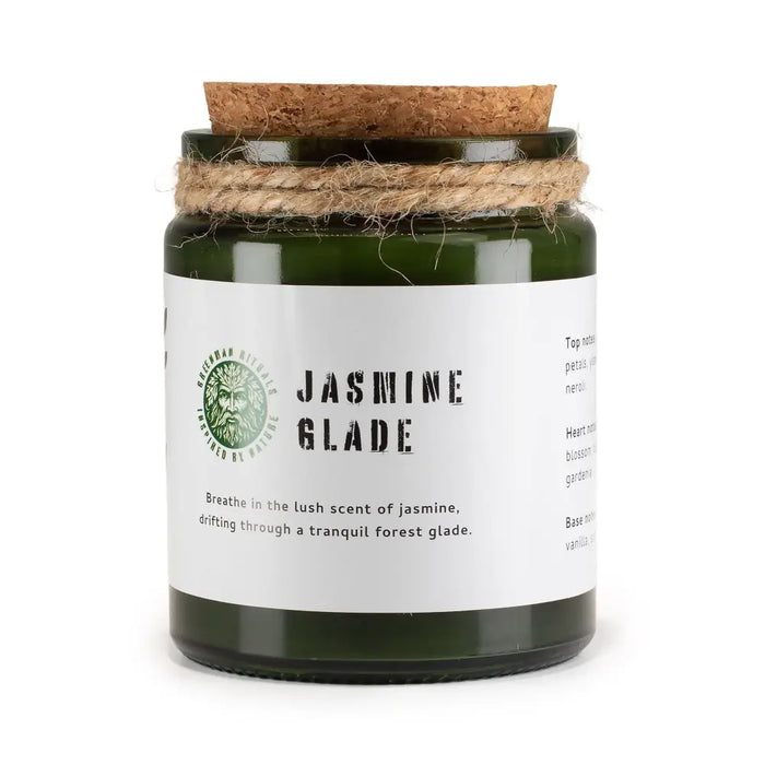 Dark green glass jar woodwick soy candle with cork lid and twine wrap labeled jasmine glade by greenman distills
