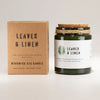 Dark green glass greenman woodwick soy candle with wooden wick cork lid tied by twine labeled leaves and linen