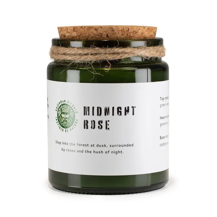 Dark green glass woodwick soy candle jar with cork lid and twine labeled midnight rose by greenman rituals