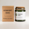 Greenman woodwick soy candle midnight rose in a dark green glass jar with cork lid and kraft paper box packaging