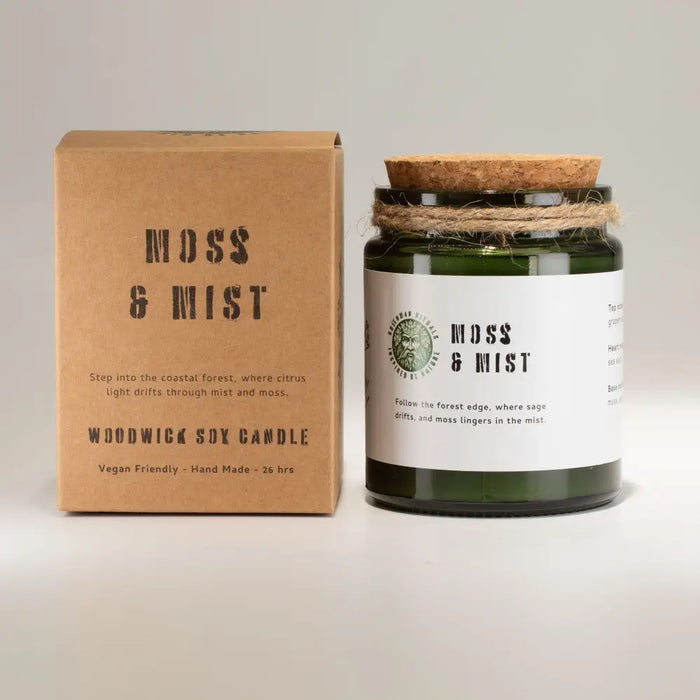 Greenman woodwick soy candle in green glass jar with cork lid and twine labeled moss and mist by woodwick