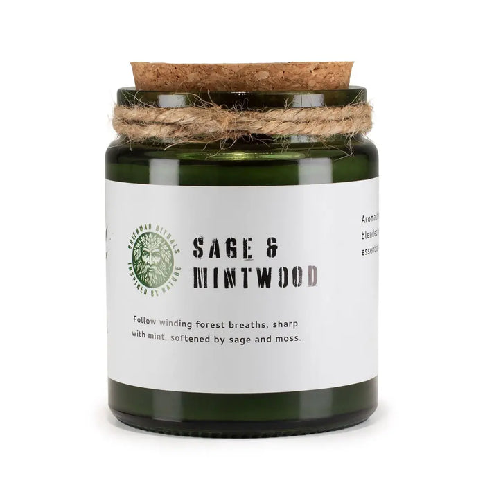 A green glass woodwick soy candle with a cork lid and twine wrap labeled sage and mintwood by greenman naturals