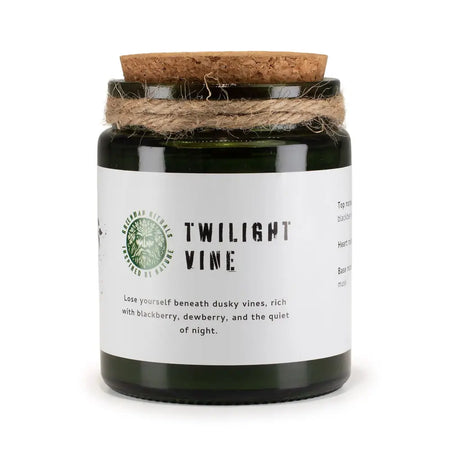 Dark green glass woodwick soy candle with cork lid and twine labeled twilight vine by greenman rituals