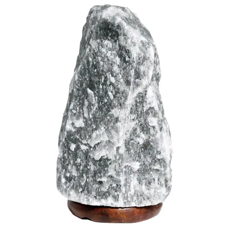A grey himalayan salt lamp with rough texture on a dark brown wooden base showing its hygroscopic properties