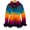 A vibrant multicolored knitted wool cardigan with a fuzzy texture and fringe details on the collar and hem