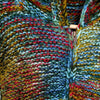 Green blue multi tonal wool hoodie with hand knitted textured pattern in red blue green yellow and white yarns