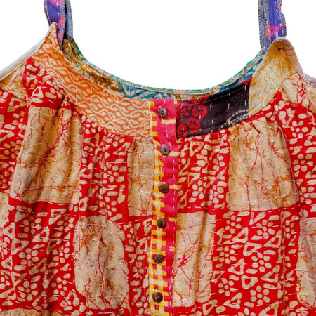 A vibrant red and beige kantha oversized overall with intricate embroidery and a button placket with yellow pink stripes