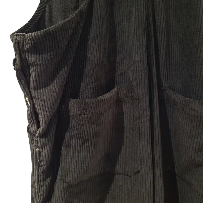 Black corduroy sleeveless vest with vertical ribs and pockets paired with gringo fairtrade jumbo cord dungarees black