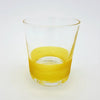Clear glass votive tealight holder with a vibrant yellow swirling band near the base in four colour options