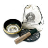 Black hand-beaten engraved singing bowl with gold rim and buddha design with wooden mallet in a bowl gift set