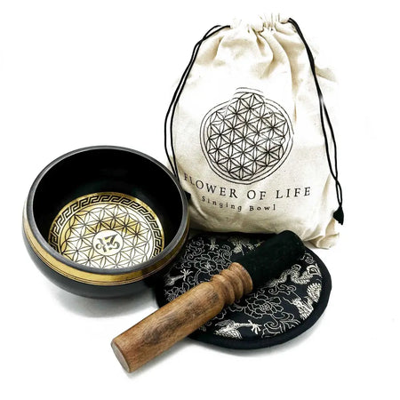 Black hand-beaten engraved singing bowl with gold flower of life design and wooden mallet in a bowl gift set
