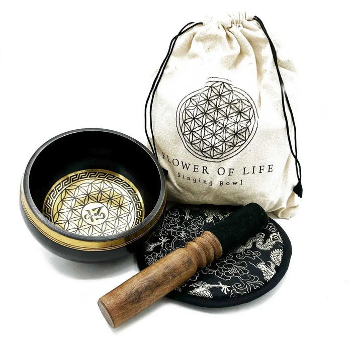 Black hand-beaten engraved singing bowl with gold flower of life design and wooden mallet in a bowl gift set