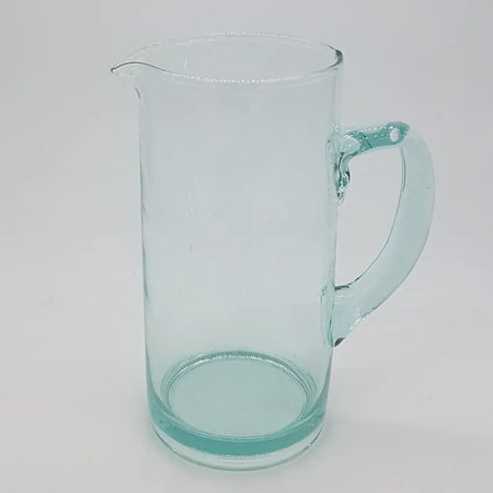 Hand-blown recycled glass tall jug with clear glass, subtle teal tint, and a curved handle for serving liquids