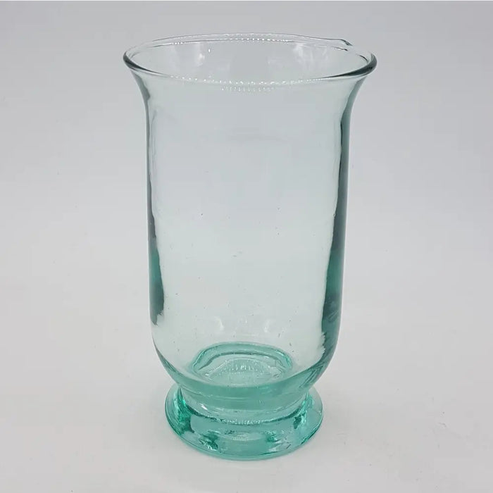 A hand-blown recycled glass vase in translucent teal with a flared rim and textured rounded base for use as a hurricane lamp